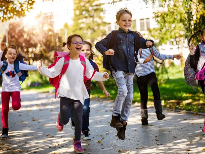 School kids running in schoolyard