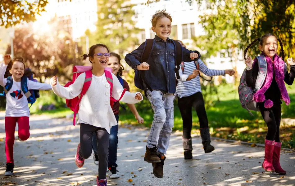 School kids running in schoolyard