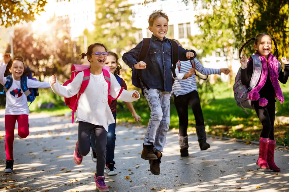 School kids running in schoolyard