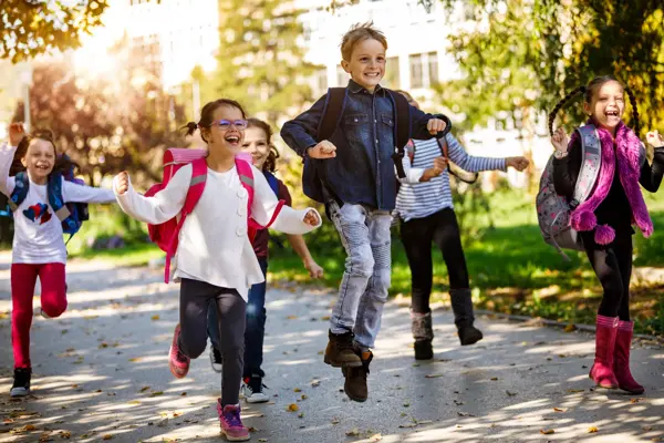 School kids running in schoolyard