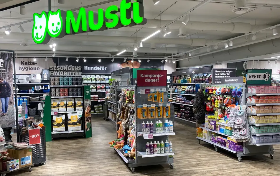 innendørs butikk med grønne skilt og reoler