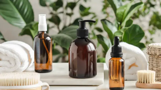 Set of female skin care products. Makeup products and skin cleansers on nature plant background. Copy space. Front view