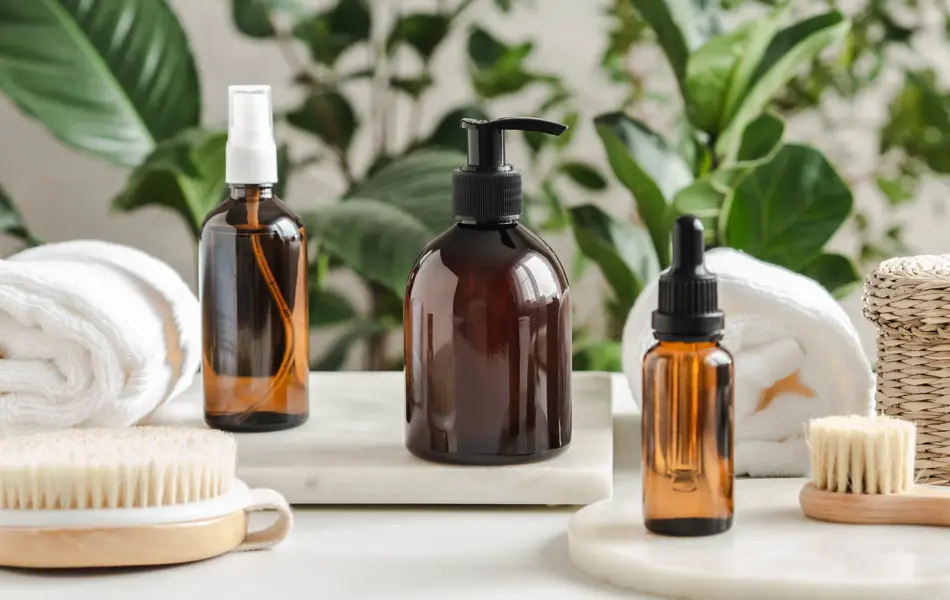 Set of female skin care products. Makeup products and skin cleansers on nature plant background. Copy space. Front view