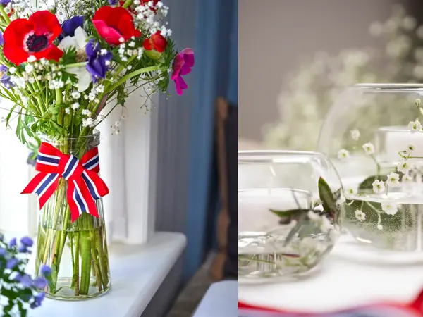 Vase med 17. mai-bånd rundt og stor bukett med fargerike blomster. To små boller fylt med vann og brudeslør og grønne grener.