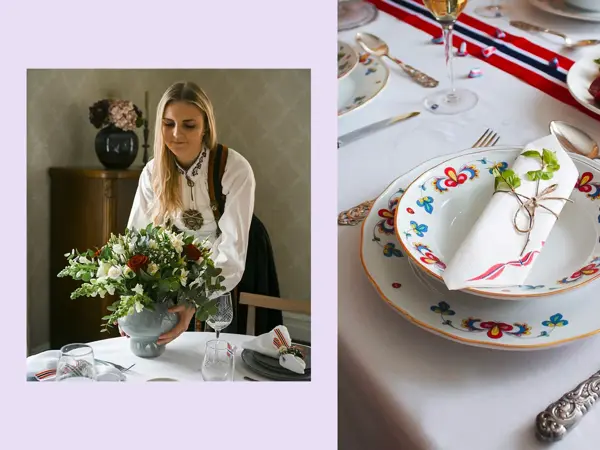 Ung dame i bundad setter en vase med blomster på bordet. Nærbilde at kuvert, bondemønstret servise og sølvbestikk.