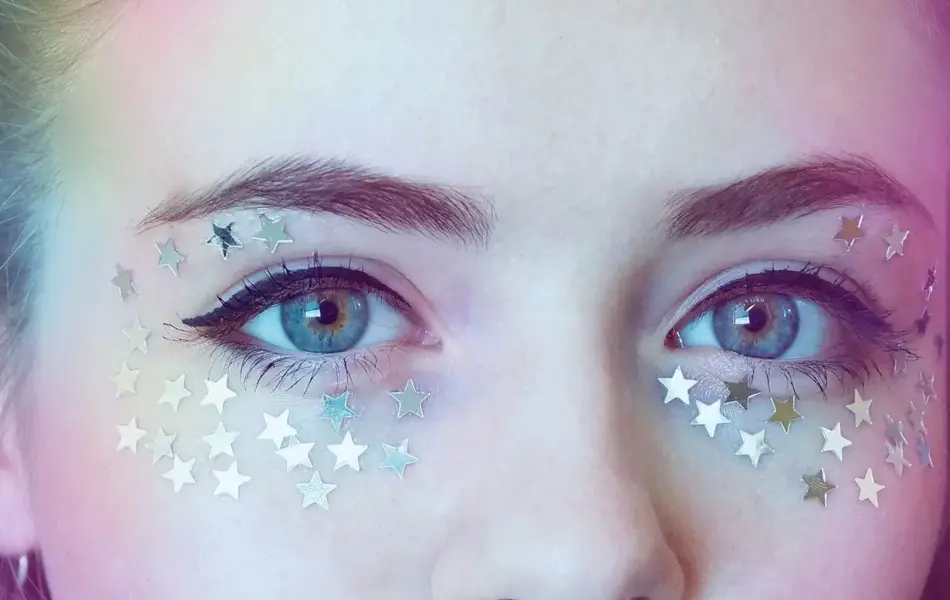 Nærbilde av en kvinne med stjerner klistret rundt øynene