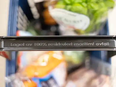 Handlekurv fra Rema 1000 med tekst på håndtaket "Laget av 100% resirkulert maritimt avfall"