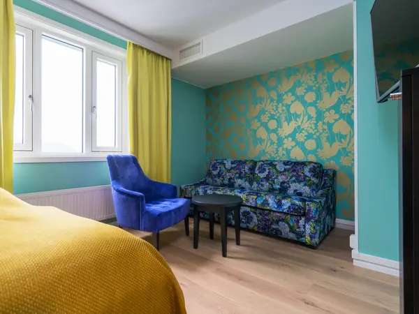 Sittegruppe med sofa og stol i superior rom på Thon Hotel Nidaros i Trondheim