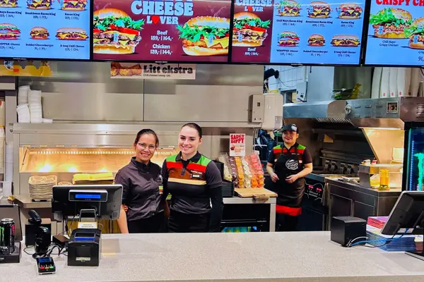 To bak disken som smiler til kameraet