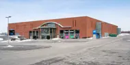Fasadebilde av Thon Senter Borg, parkeringsplass og inngang bakside.