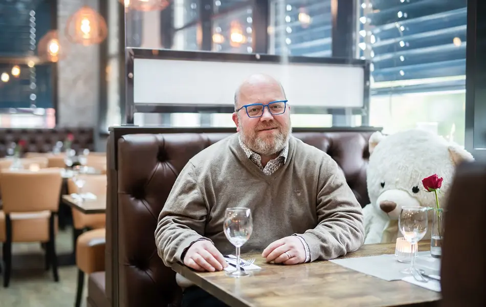 Bilde av mann ved bord i restaurant