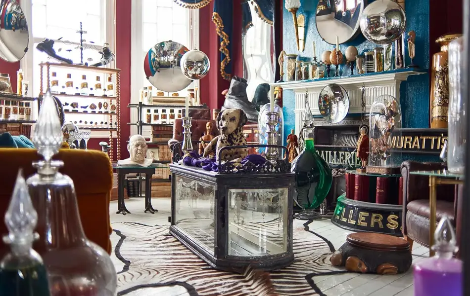 Eklektisk stue fullt av møbler og antikviteter