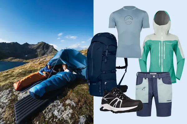 To personer i sovepose på et fjell, tusekk, t-skjorte, vindtett jakke, shorts og tursko.