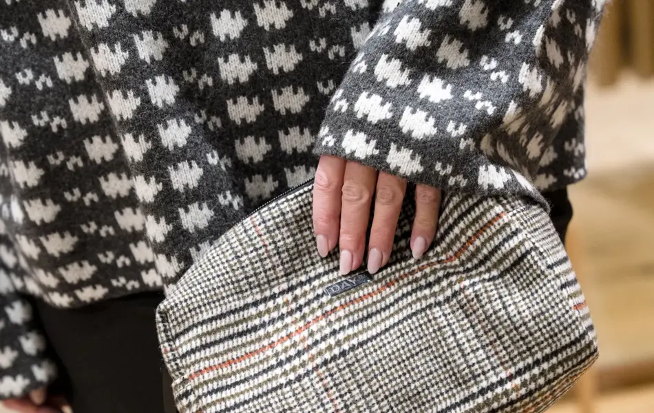 hånd holder en rutete veske