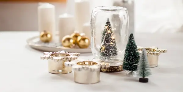 Glass med juletre, stearinlys, julekuler og diverse julepynt