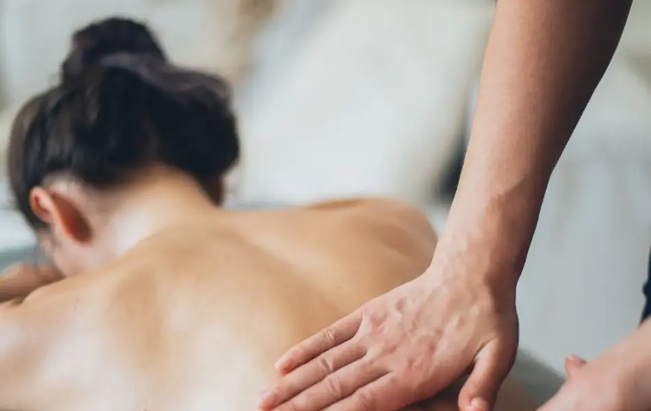 dame som blir massert på ryggen