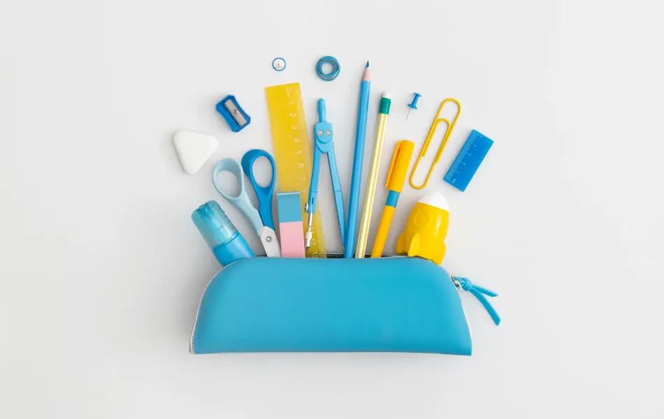 Pencil case with school stationery on a grey background. Top view. Flat lay. Back to school concept.