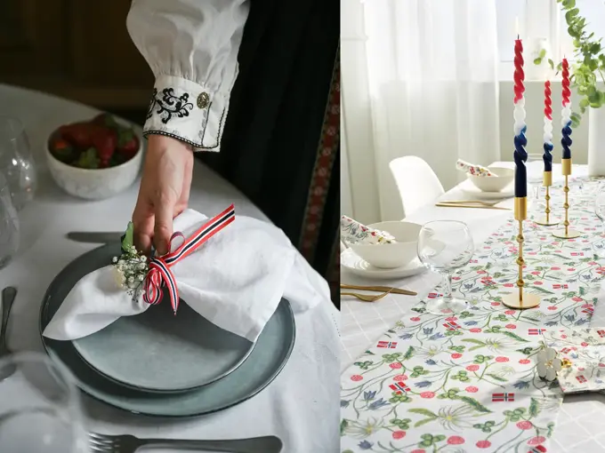 Damehånd legger en tøyserviett på grå tallerken. Bord pyntet til 17. mai.