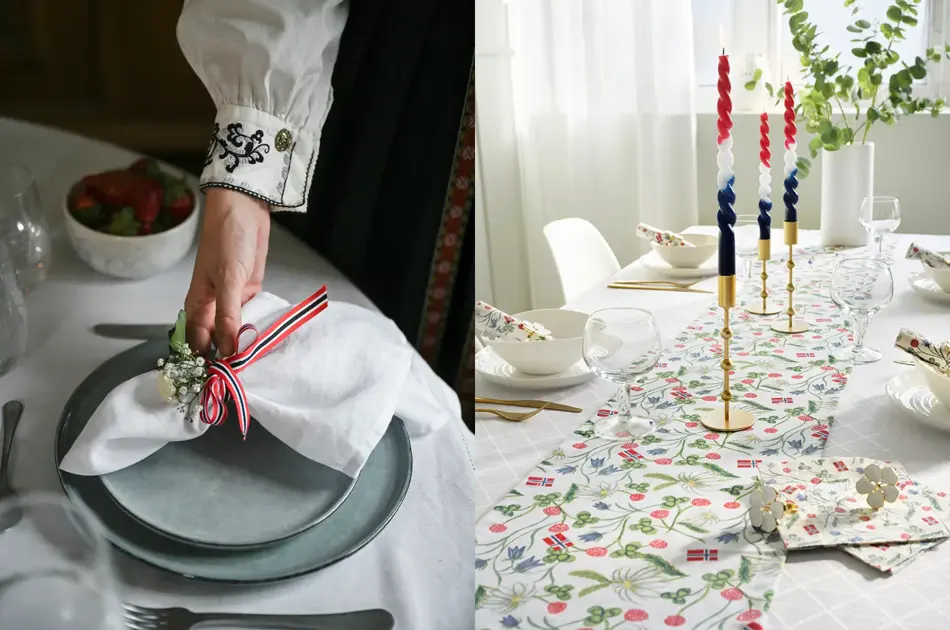 Damehånd legger en tøyserviett på grå tallerken. Bord pyntet til 17. mai.