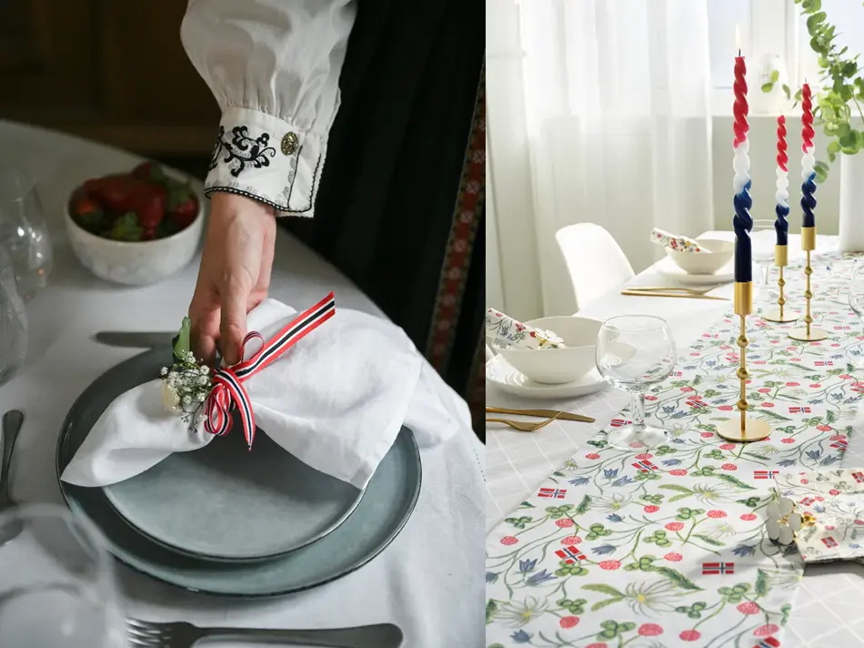 Damehånd legger en tøyserviett på grå tallerken. Bord pyntet til 17. mai.