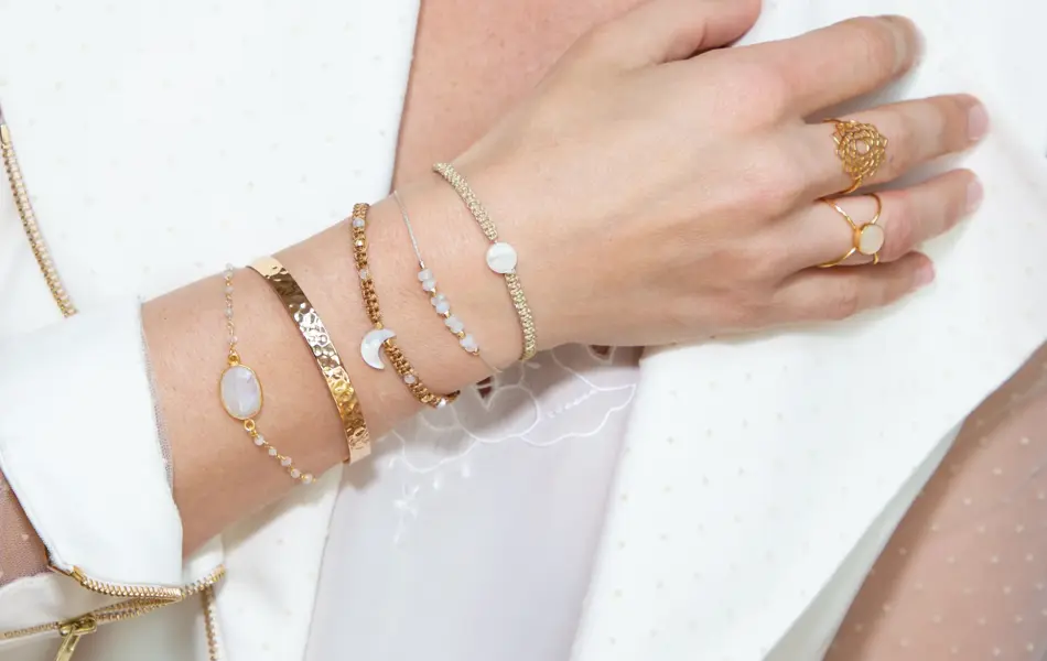 woman neck with hand with many bracelets