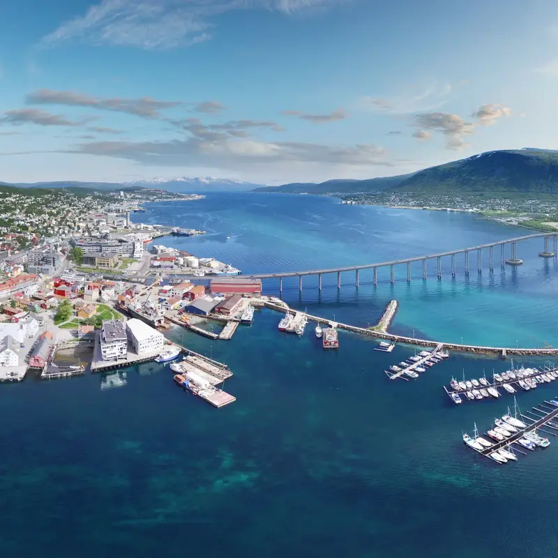 This is an aerial panoramic view over Tromso Bridge crossing Norwegian Sea. It connects Tromsdalen on the mainland and the island of Tromsøya.