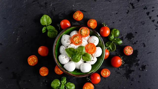 Tomatoes and mozzarella, italian food background, top view