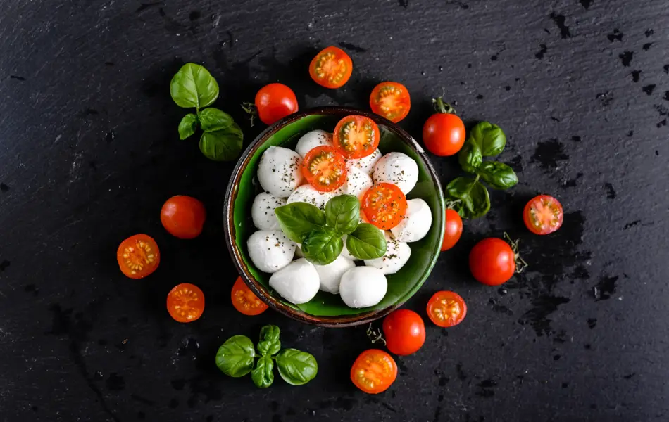Tomatoes and mozzarella, italian food background, top view