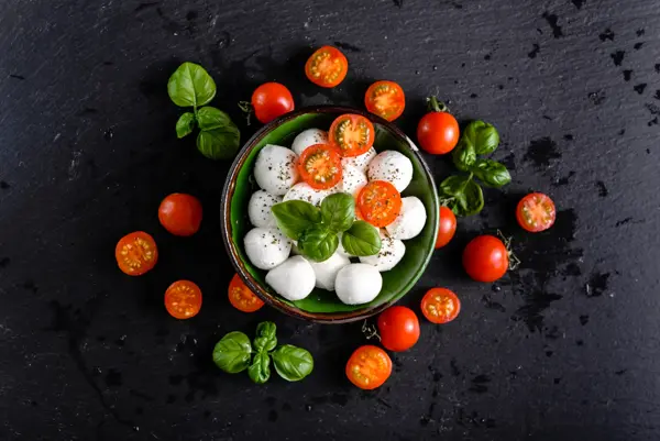 Tomatoes and mozzarella, italian food background, top view