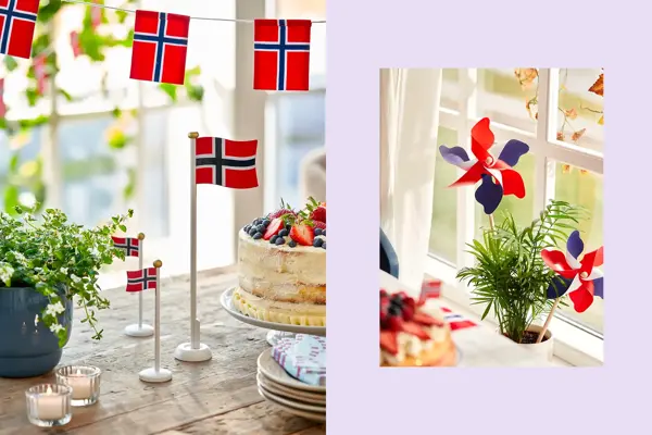 Bordflagg på et trebord med grønn plante og kake. Vindmøller står i en potteplante.