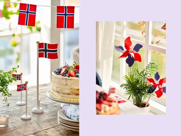Bordflagg på et trebord med grønn plante og kake. Vindmøller står i en potteplante.