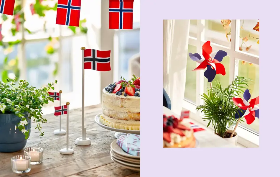 Bordflagg på et trebord med grønn plante og kake. Vindmøller står i en potteplante.