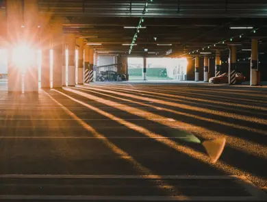 St Petersburg / Russia - 25 May 2020:  An empty covered Parking lot with blue license plates lit up by the setting sun