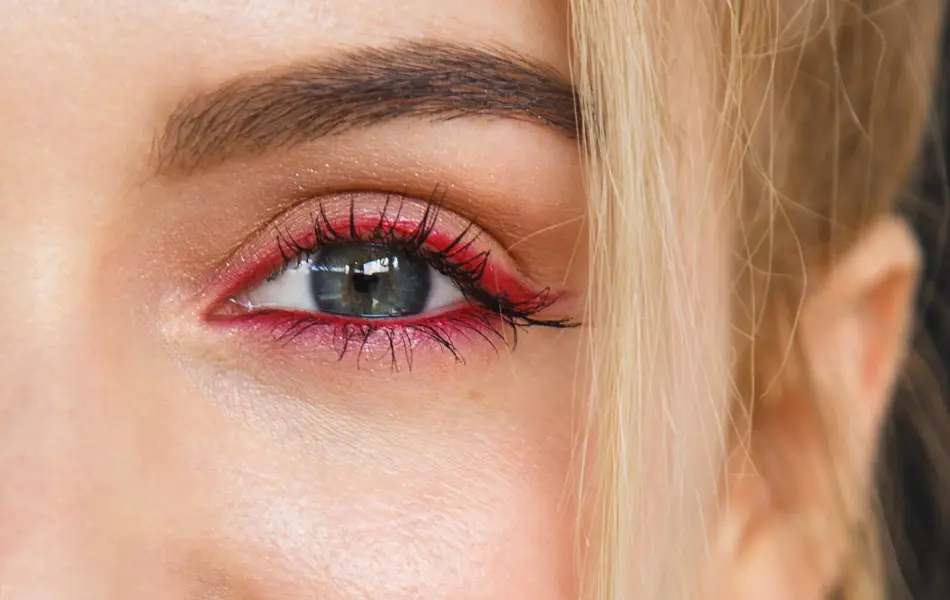 Close up on half face of a gorgeous smile of a beautiful happy blonde woman. Her lips are painted with bright red lipstick, skin is soft and natural and do not miss her stunning white teeth.