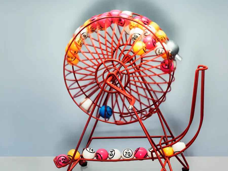 A bingo machine front on contains bingo balls  moving excitingly around