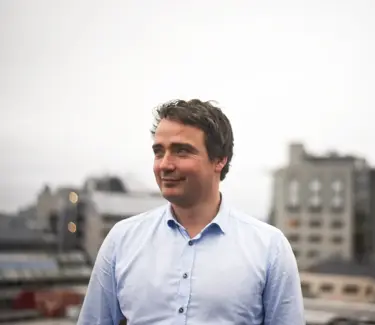 Portrettbilde av Jarle Andersen Aasness. Han smiler. 