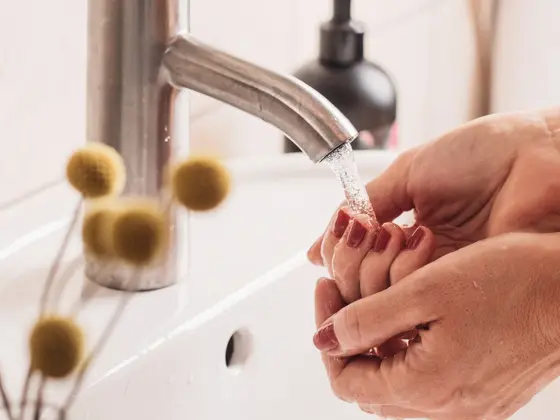 Woman cleaning washing hands in bathroom sink
Candid photo taken indoors in bathroom