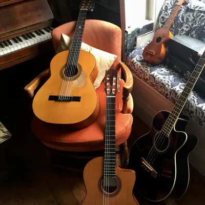 Collection of musical instruments, 3 guitars a ukulele and piano in the living room, sydney, australia