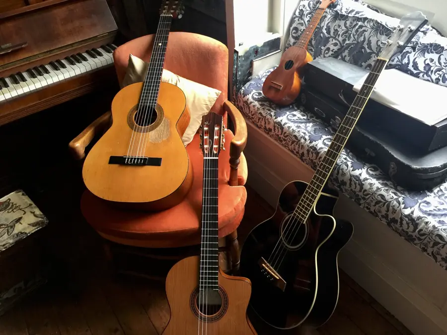 Collection of musical instruments, 3 guitars a ukulele and piano in the living room, sydney, australia