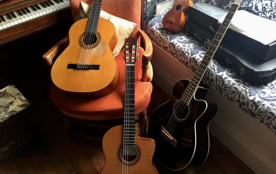 Collection of musical instruments, 3 guitars a ukulele and piano in the living room, sydney, australia