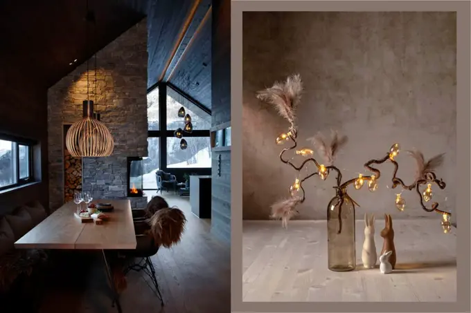Inne i en fjellhytte med langt spisebord og taklampe over. Bord med vase med grener og lysslynge.