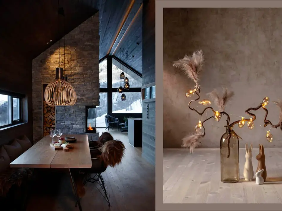 Inne i en fjellhytte med langt spisebord og taklampe over. Bord med vase med grener og lysslynge.