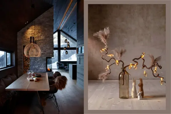 Inne i en fjellhytte med langt spisebord og taklampe over. Bord med vase med grener og lysslynge.
