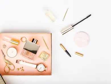 woman make up tools and stylish fashion accessories flying from gift box on white background. celebration, beauty, jewelry and shopping concept. trendy flat lay composition, top view