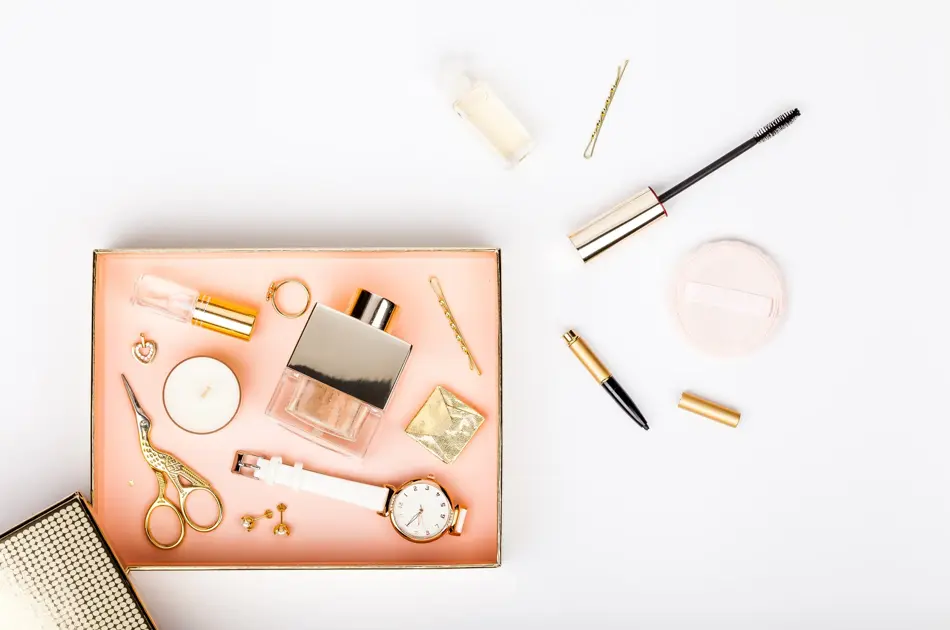 woman make up tools and stylish fashion accessories flying from gift box on white background. celebration, beauty, jewelry and shopping concept. trendy flat lay composition, top view