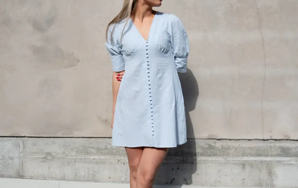 Ung dame i lyseblå linkjole og sorte pumps