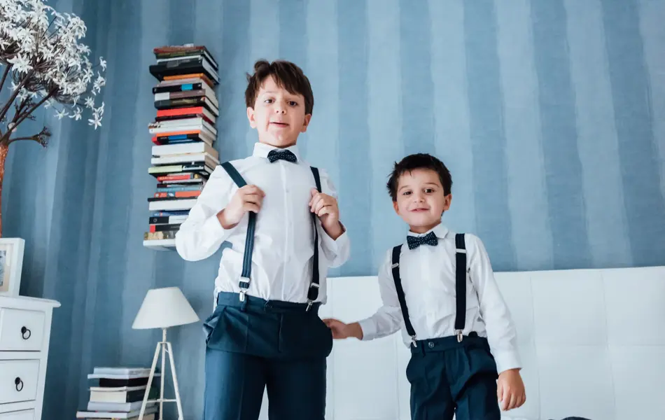 Cute little boys playing indoors. They are preparing for their uncle and aunt wedding.