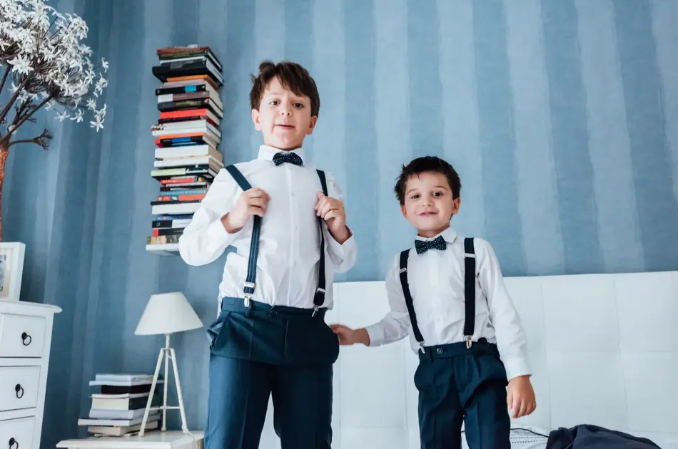 Cute little boys playing indoors. They are preparing for their uncle and aunt wedding.