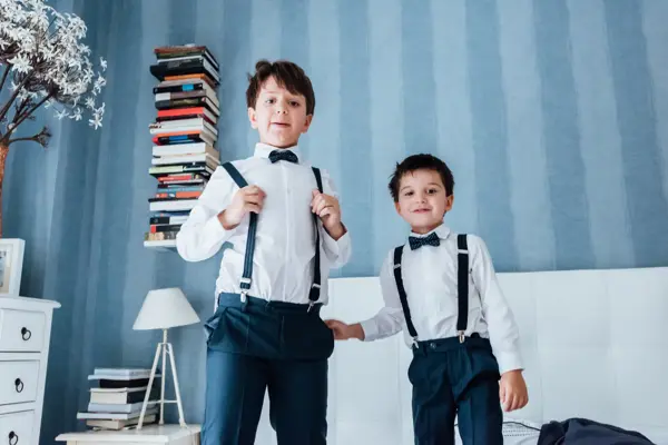 Cute little boys playing indoors. They are preparing for their uncle and aunt wedding.