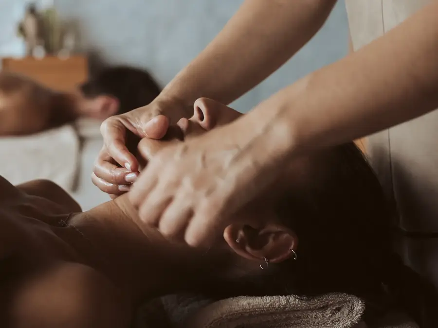 Woman having a facial massage at the spa
